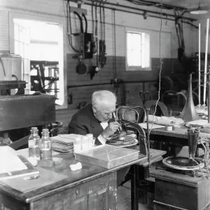 Thomas Edison Regardant à travers le Microscope.