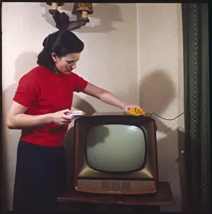 Vintage Domestic Scene Stampe: Dusting a Television