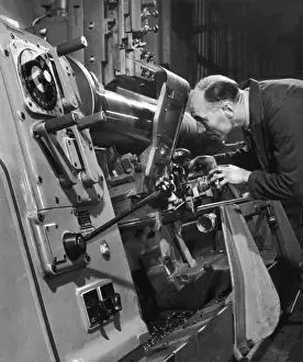 Industrial Manufacturing Process Stampe: A lathe operator at work