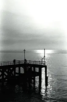 Setting Sun On The Sea Stampe: Sunset over a pier