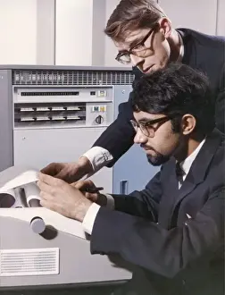 Heinz Zinram Photography Stampe: Two technicians check a computer printout