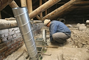 Building Renovation Stampe: Worker installing ventilation