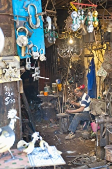 Marrakech Souk Stampe: Carpenter and metalworker in his workshop in the souk