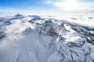 Veneto Region Italy Tourism Stampe: Snow capped Monte Pelmo emerging from clouds, aerial view, Dolomites, Belluno province