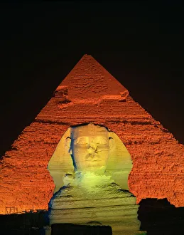Egyptian Archaeological Sites Stampe: The Sphinx and one of the pyramids illuminated at night, Giza, UNESCO World Heritage Site