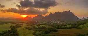 Mauritius Landscape Stampe: View of golden sunset behind Long Mountain and patchwork of green fields