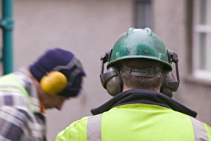 Construction Worker Safety Gear Stampe: Workmen using ear protectors