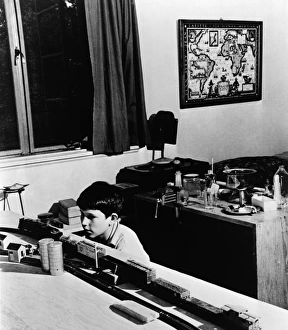 Vintage Bedroom Decor Stampe: MODEL TRAIN, c1944. A boy plays with a model train set in his bedroom, Greenbelt, Maryland