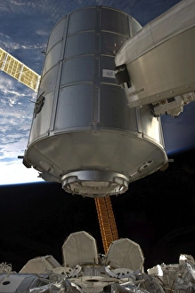 International Space Station Stampe: The Permanent Multipurpose Module in the grasp of Canadarm2