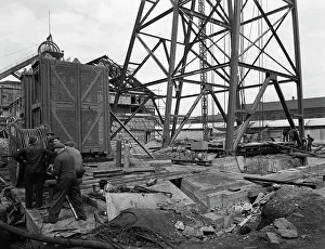 British Coal Industry Stampe: Installing a cage at Hickleton Main pit, Thurnscoe, South Yorkshire, 1961. Artist