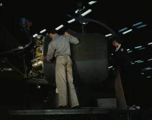 Aeronautical Engineer Stampe: Lowering an engine in place in assembling a C-87