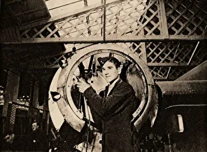 Metal Worker Stampe: A metal worker with automatic drill stripping an engine casing, 1940