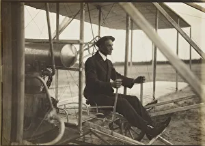 Early Aviation Images Stampe: Wilbur Wright in the flyer, 1908. Creator: Anonymous