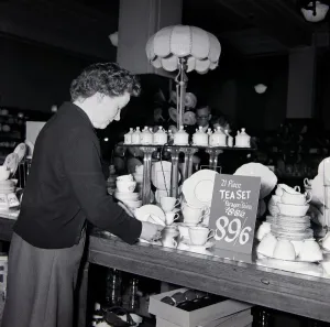 Kensington High Street History Stampe: An elderly lady looking for bargains during january sales at Derry