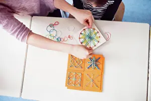 Classroom Learning Tools Stampe: Top view of teacher using geoboard in class