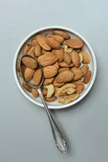 Food Photography Bowl Stampe: Almonds and walnuts in shell with spoon