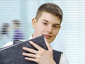 Business Professional Portrait Stampe: Apprentice or trainee holding files in an office
