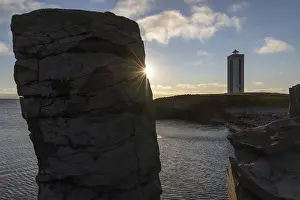 Icelandic Coastal Scenery Stampe: Basalt column and lighthouse in the backlight