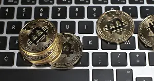 Digital Currency Symbol Stampe: Bitcoins on Computer Keyboard Background
