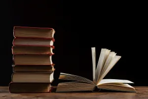 Stacked Hardcover Books Stampe: Books stack with dark background