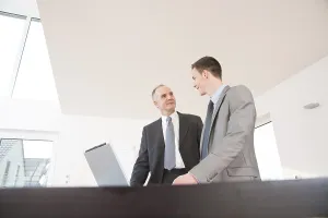 Businessman In Suit Stampe: Boss and trainee working together on a computer