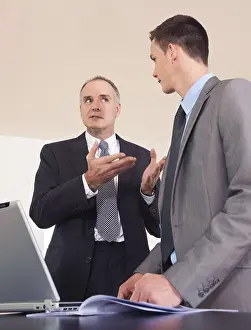Office Work Clothes Stampe: Boss and trainee working together on a computer