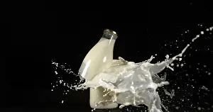 Black Background Photography Stampe: Bottle of Milk Exploding against Black Background