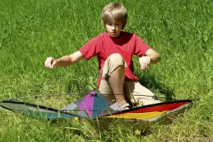 Handicrafts For Kids Stampe: Boy assembles a stunt kite