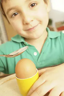 Balanced Diet For Kids Stampe: Boy eats an egg