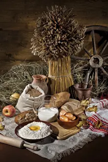 Wholemeal Bread Stampe: Bread, flowers, ild tableware on a canvas studio background