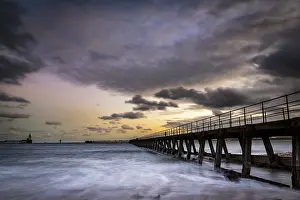 Overcast Sky In Europe Stampe: Bridge in the sea with dramatic clouds at sunset