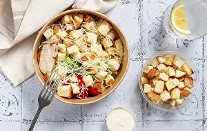 Caesar Salad Stampe: Caesar salad in a paper container