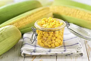 Tin Can Food Stampe: Canned sweet corn in jar on a white table