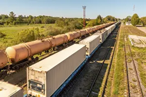 Train Platform Stampe: Cargo train platform with white freight containers on the train