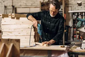 Handicraft Profession Stampe: Carpenter using electric drill