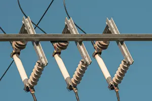 Power Industry Equipment Stampe: Ceramic eletric insulators outside on the sky background
