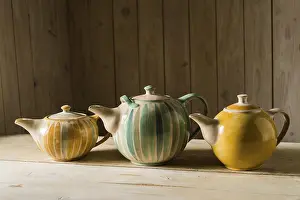 Pottery Making Process Stampe: Ceramic workshop, three glazed pots on workbench