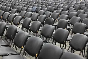 Empty Chair Rows Stampe: Chairs covered with gray plastic stand in rows in a function room