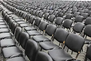 Empty Chair Rows Stampe: Chairs covered with gray plastic stand in rows in a function room