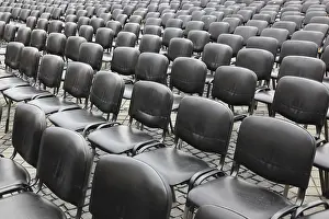 Empty Chair Rows Stampe: Chairs covered with gray plastic stand in rows in a function room