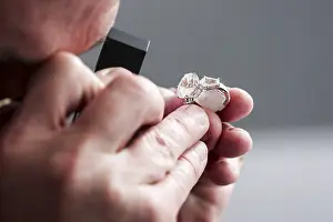 Gemstone Inspection Stampe: Checking a ring with a gemstone for authenticity