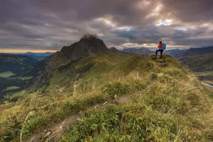 Cloudy Alpine Landscape Stampe: Climber looking on the summit of the Widderstein