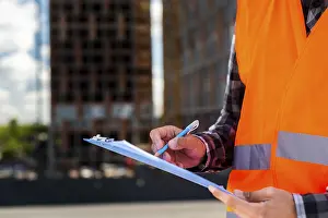 Self Confident Worker Stampe: Close up construction engineer writing