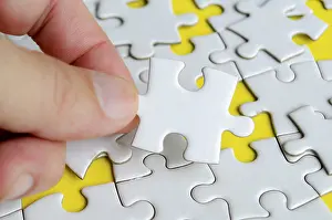Close Up Jigsaw Puzzle Stampe: Close up of hand place missing jigsaw puzzle representing problem solving skill