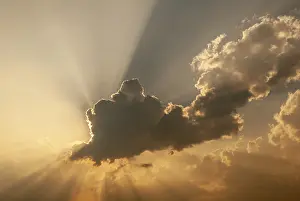 Deserted Landscape France Stampe: Cloud in front of the sun showing rays of light