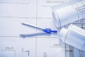 Real Estate Market Stampe: Compass and two rolled up white blueprints horizontal version