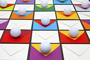 Colorful Office Supplies Stampe: Composition with colored envelopes and golf balls on the table