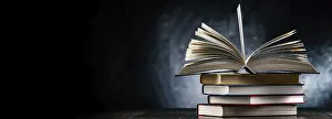 Stacked Literature Stampe: A composition with an open book lying on a stack of other books