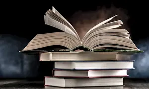Educational Institution Stampe: A composition with an open book lying on a stack of other books