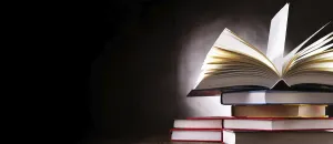 Deserted Library Scene Stampe: A composition with an open book lying on a stack of other books